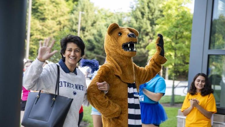 Nittany Lion mascot, left, waves to the crowd with Chancellor Pyati, right